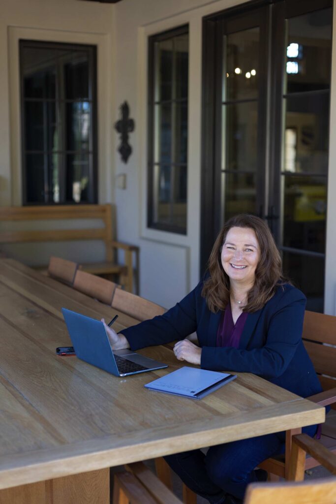 Kathleen Clark sitting at a table with computer